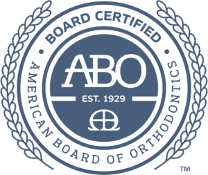 At Levine Orthodontics in Fort Myers, Cape Coral, or Lehigh Acres, FL, our circular logo features "BOARD CERTIFIED" and "AMERICAN BOARD OF ORTHODONTICS" around the acronym "ABO" and a central symbol.
