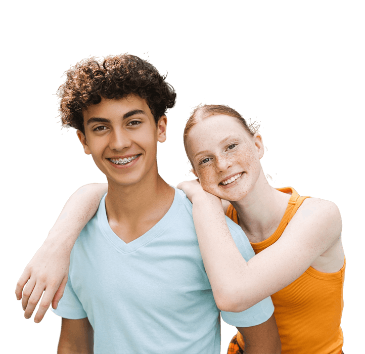 Smiling in front of a light blue background, two teenagers—one with their arm around the other's shoulders—proudly display their orthodontic appliances, courtesy of Levine Orthodontics in Fort Myers, FL.