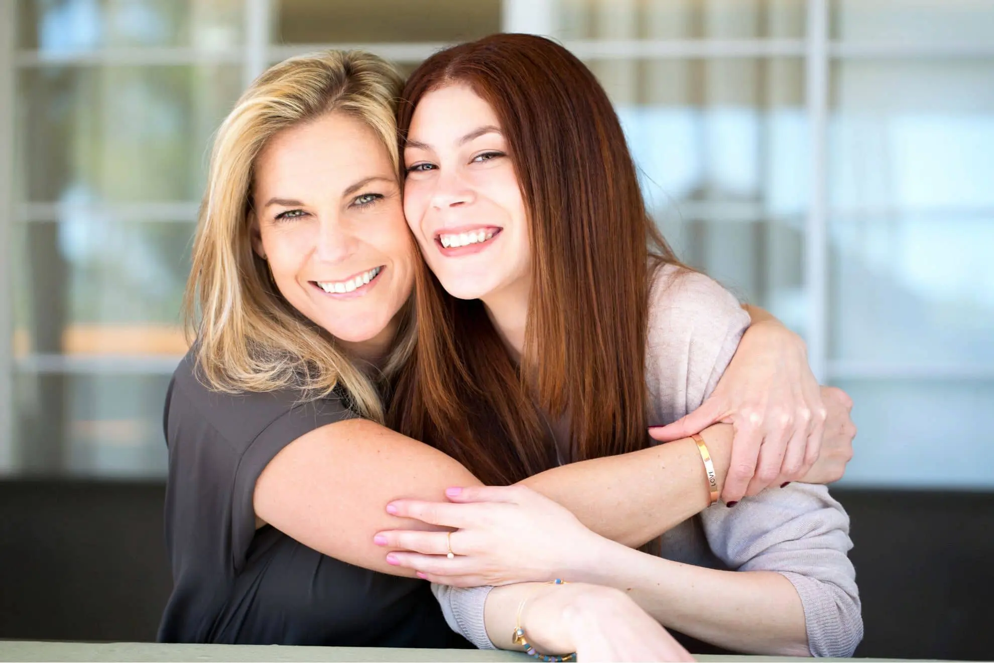 A smiling mother hugs her daughter after scheduling a free Invisalign clear aligner consultation at Levine Orthodontics in Cape Coral, FL, symbolizing family-centered, personalized orthodontic care.