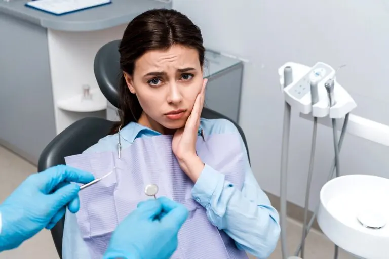 selective focus dentist latex gloves holding dental instruments upset woman - TMJ Treatment in Fort Myers, Cape Coral, and Lehigh Acres, FL