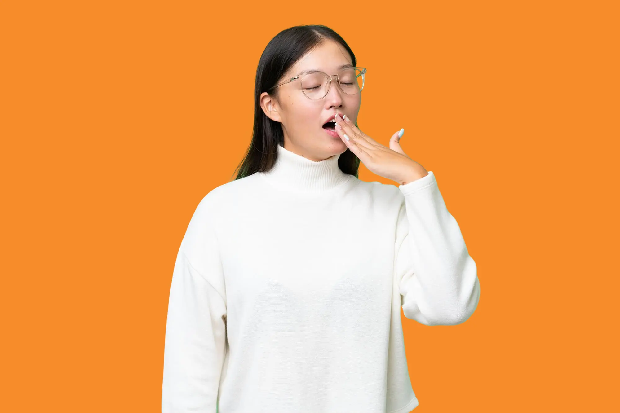 A woman yawning and covering her mouth, illustrating airway concerns and the importance of Airway Orthodontics at Levine Orthodontics in Fort Myers, FL.