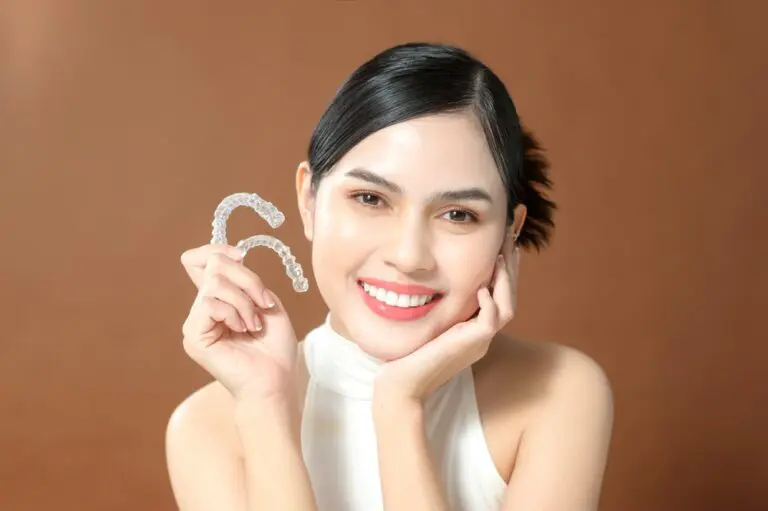 young woman beautiful teeth holding invisalign clear aligners healthy dental concept - How Long Does Invisalign Take in Fort Myers, Cape Coral, and Lehigh Acres, FL